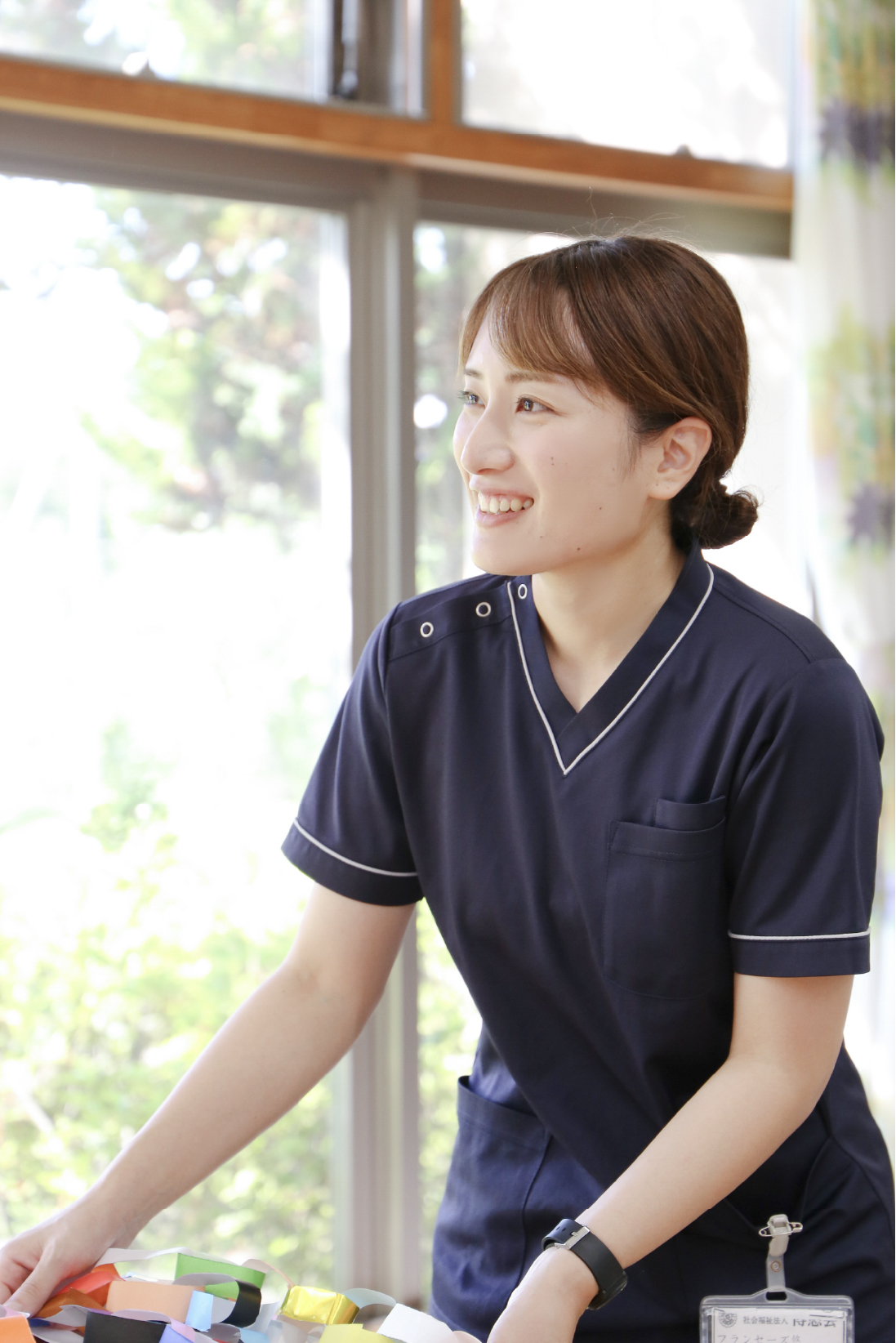 折り紙を持つ笑顔の女性職員